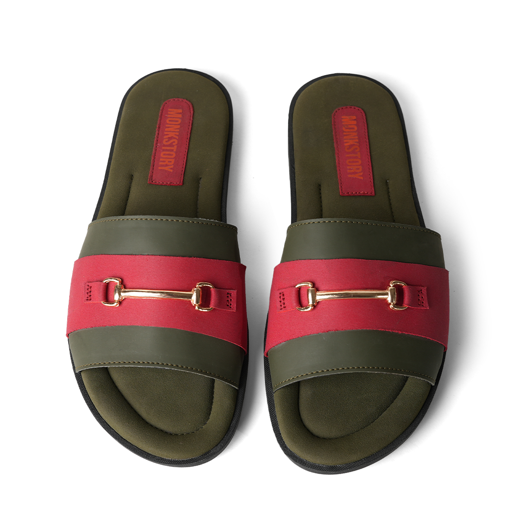 These stylish Horsebit Slides - Red from Monkstory feature a red and green color combination, adorned with gold buckles for added elegance. Offering both comfort and trendy aesthetics, they are perfect for casual outings or lounging by.