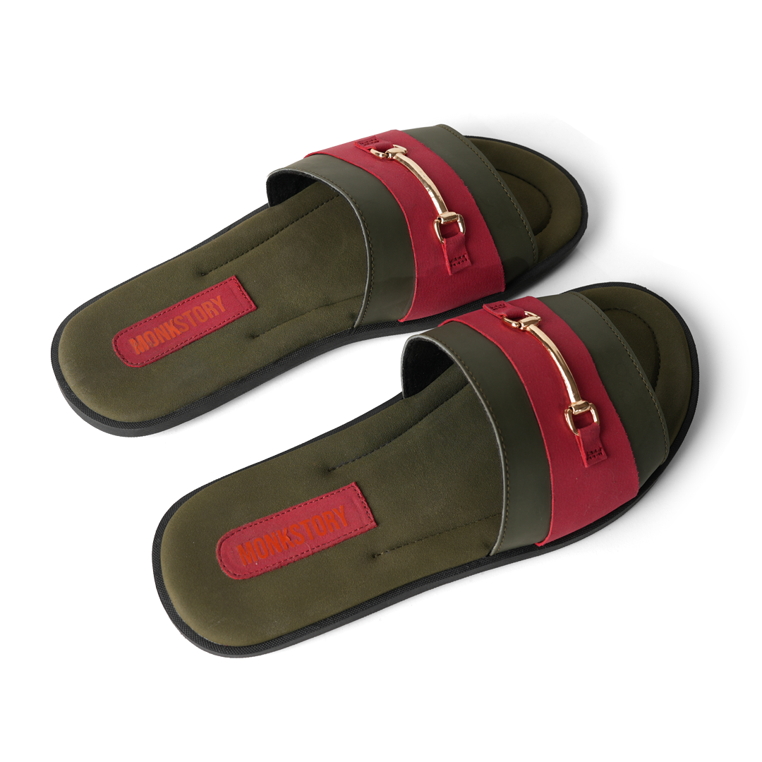These stylish Horsebit Slides - Red from Monkstory feature a red and green color combination, adorned with gold buckles for added elegance. Offering both comfort and trendy aesthetics, they are perfect for casual outings or lounging by.