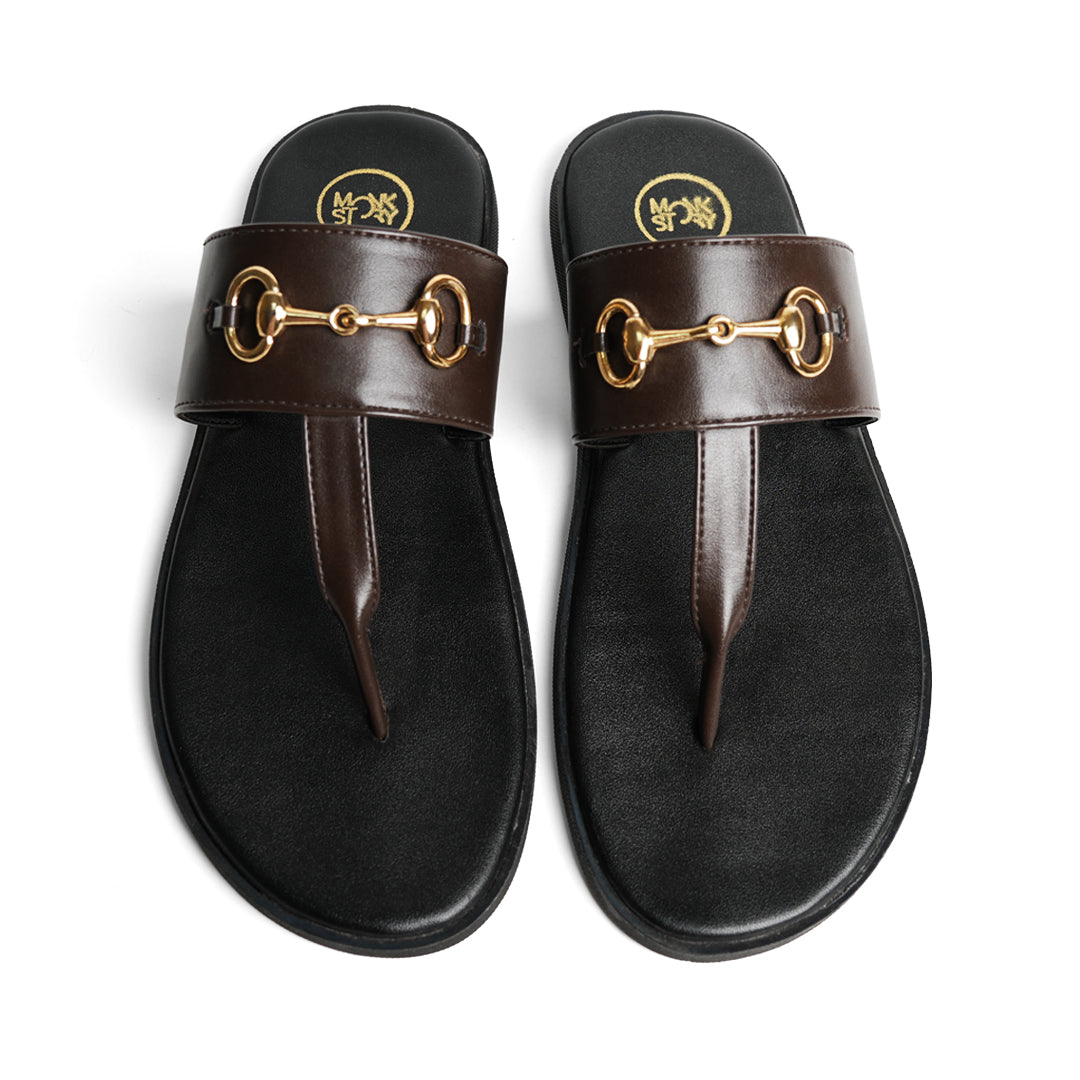 A pair of Monkstory T-Rad Horsebit sandals with gold buckles and grip-centric soles.