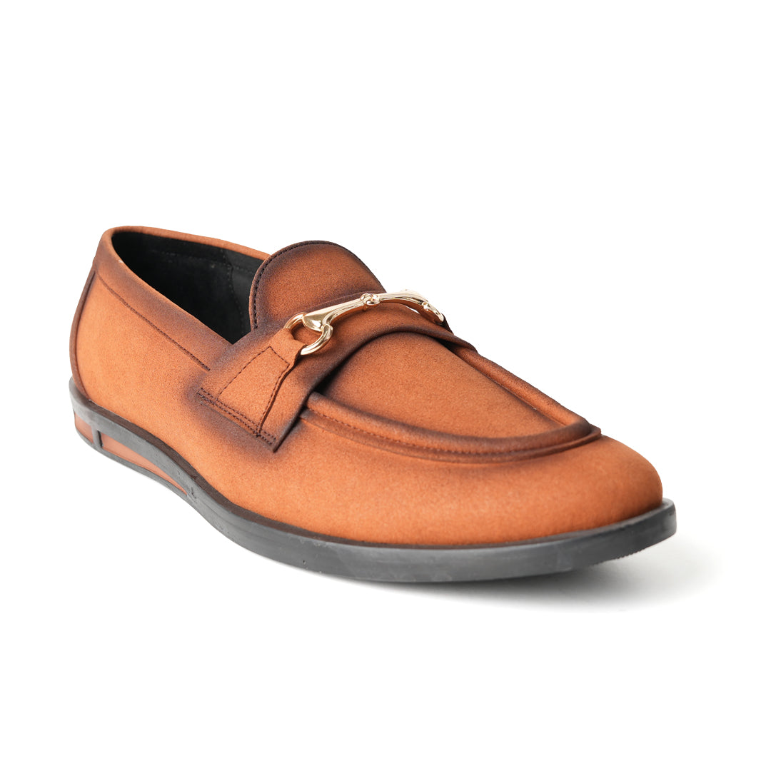 A pair of Flatform Suede Horsebit Slip Ons - Burnish Brown loafers with a gold buckle from Monkstory.