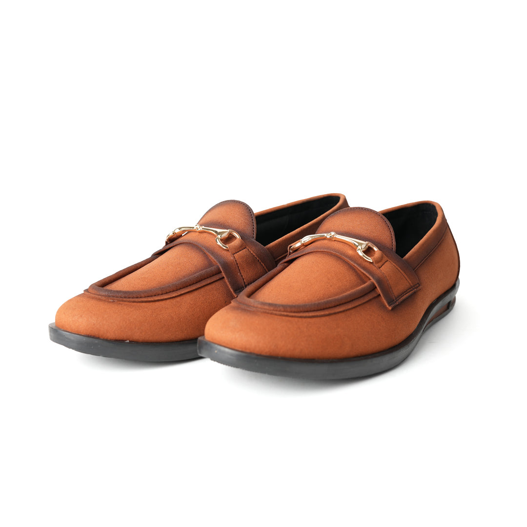 A pair of Flatform Suede Horsebit Slip Ons - Burnish Brown loafers with a gold buckle from Monkstory.