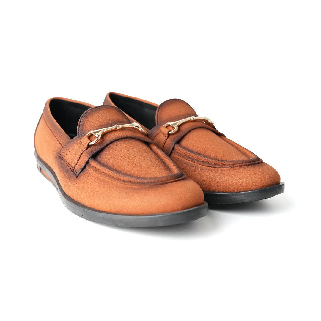 A pair of Flatform Suede Horsebit Slip Ons - Burnish Brown loafers with a gold buckle from Monkstory.