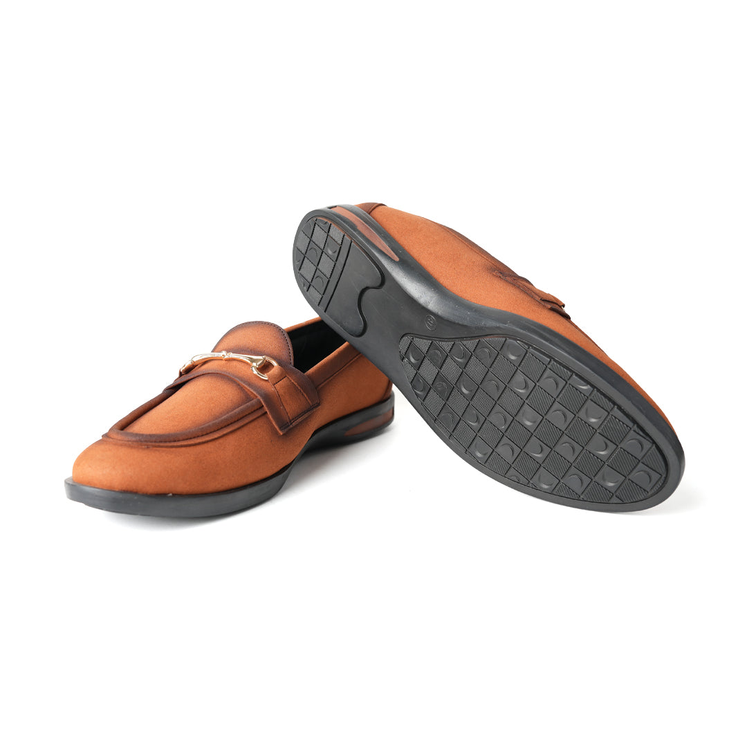 A pair of Flatform Suede Horsebit Slip Ons - Burnish Brown loafers with a gold buckle from Monkstory.