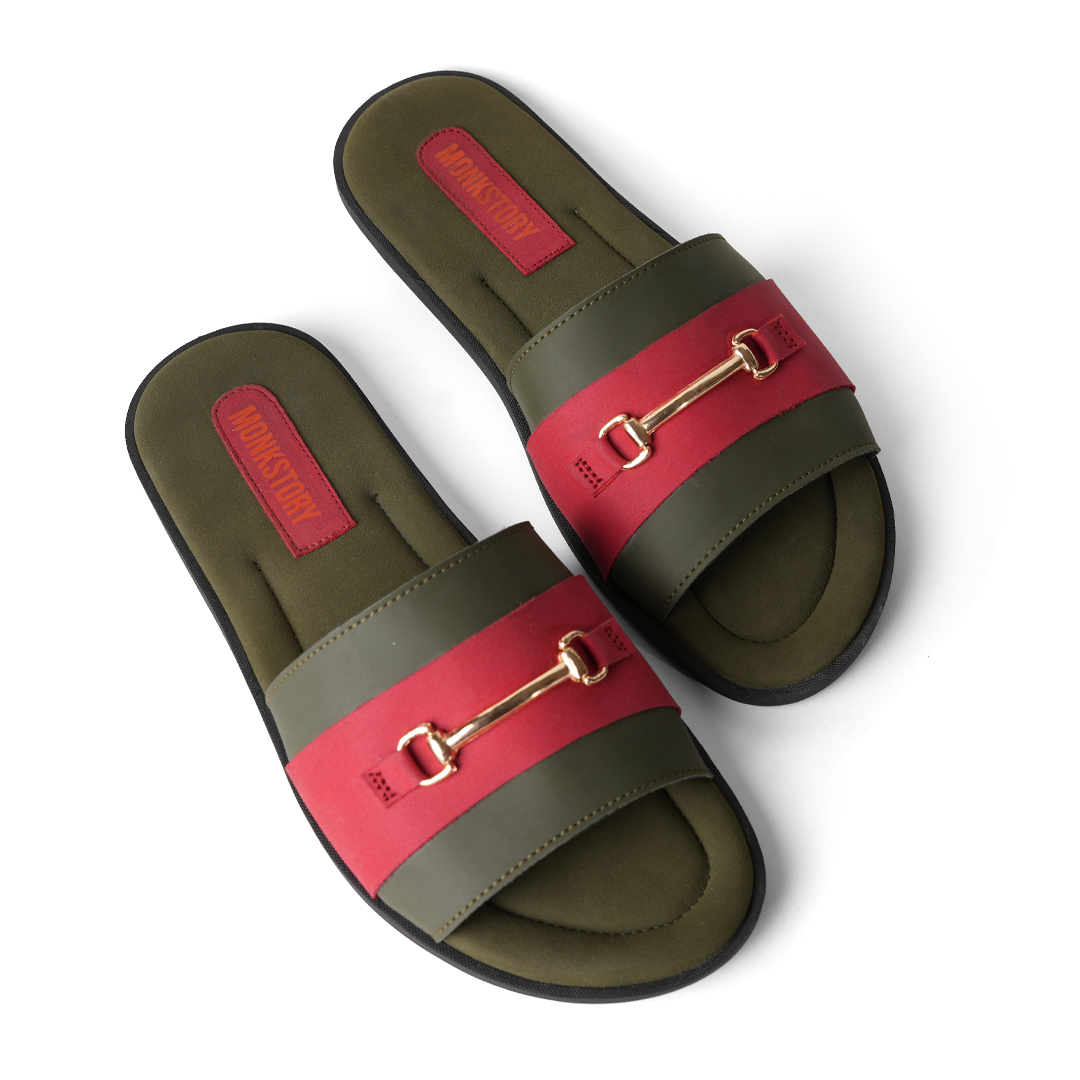 These stylish Horsebit Slides - Red from Monkstory feature a red and green color combination, adorned with gold buckles for added elegance. Offering both comfort and trendy aesthetics, they are perfect for casual outings or lounging by.