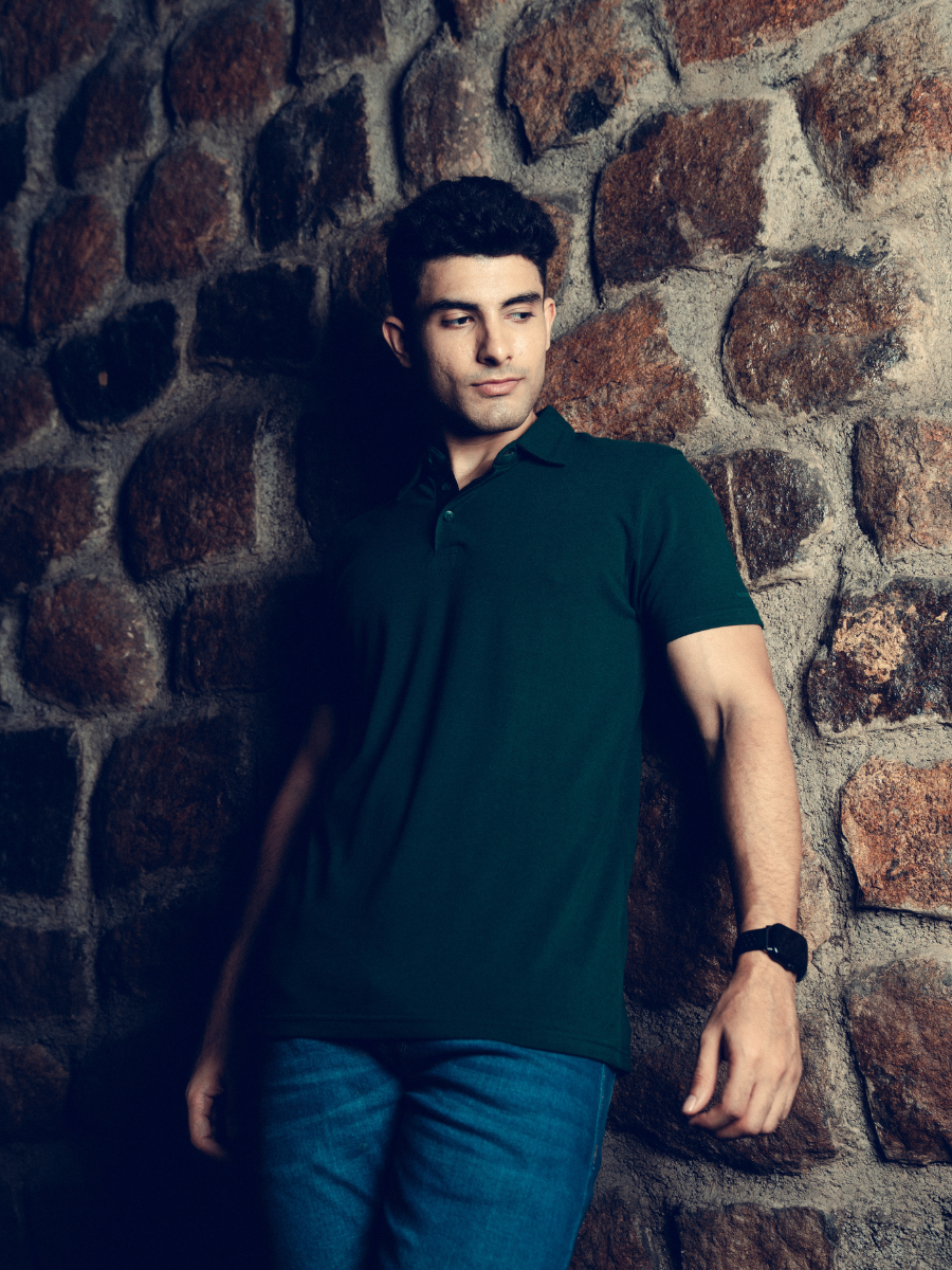 A man wearing a Monkstory Bamboo Cotton Polo Tee - Pine Green, a versatile option from Monkstory.