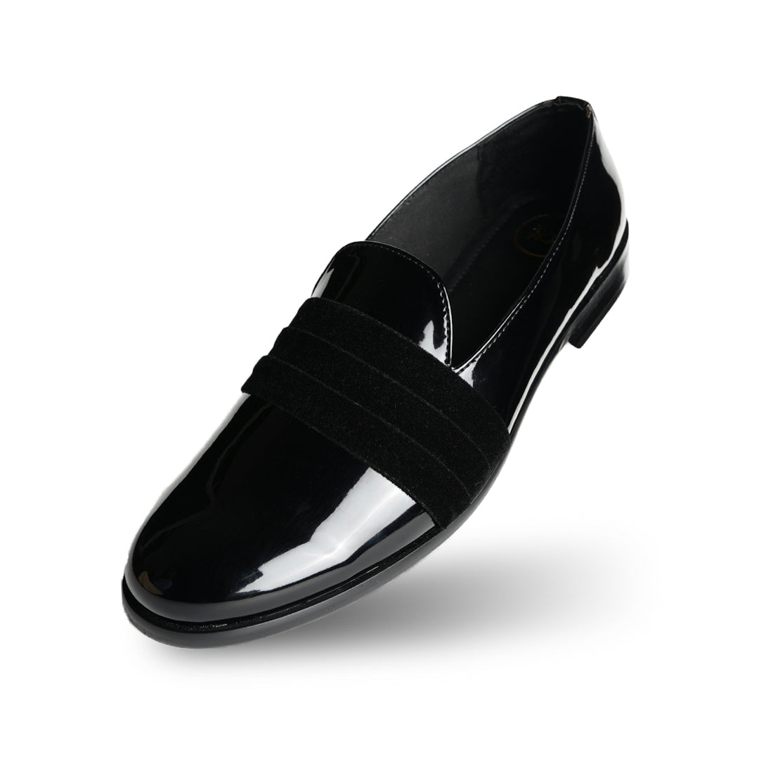 A black Tuxedo Slip-on with a patent leather finish and a bow on the side, by Monkstory.