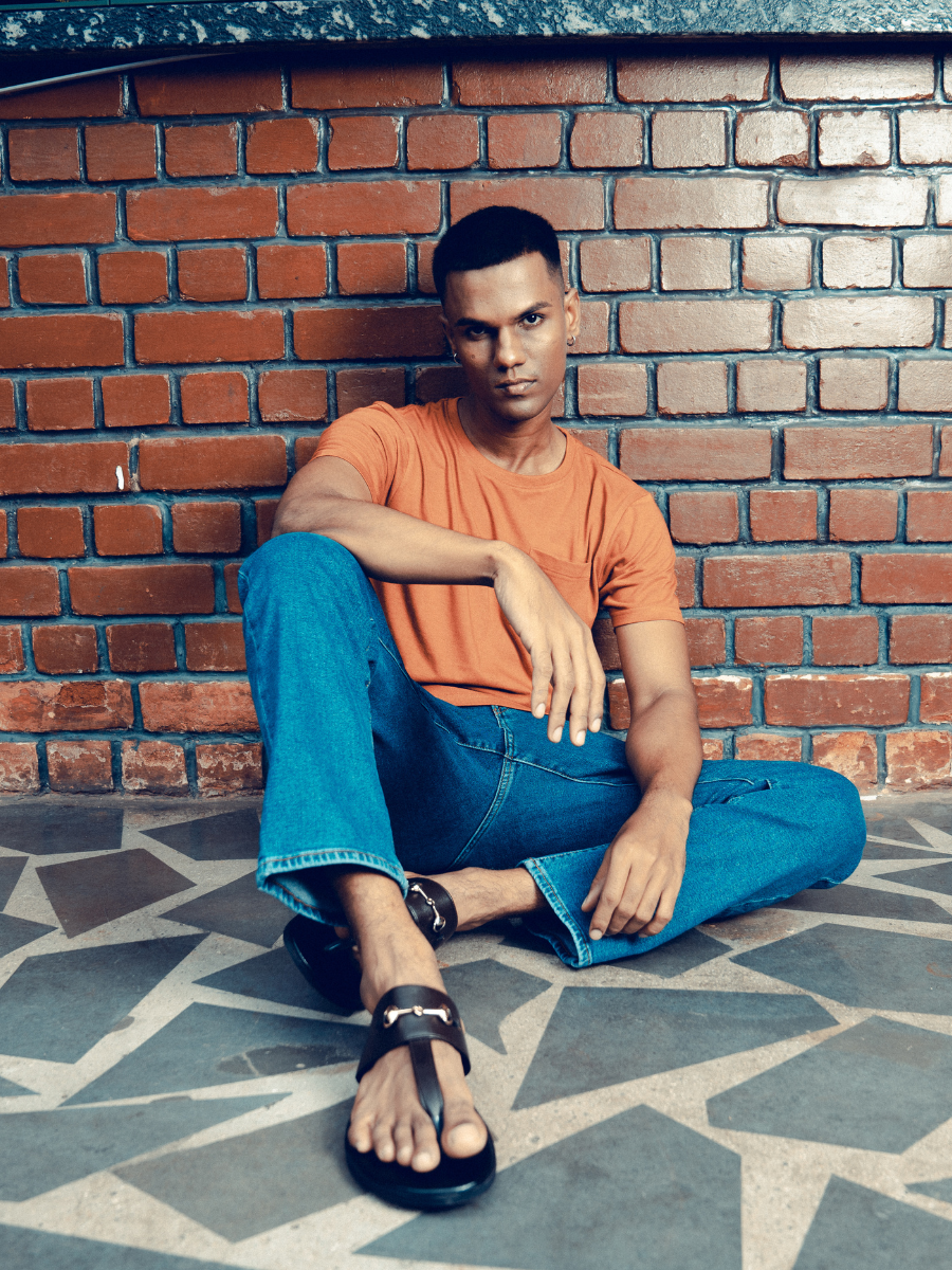 A man wearing a Monkstory bamboo cotton crew tee with a pocket, in Rusty Orange.