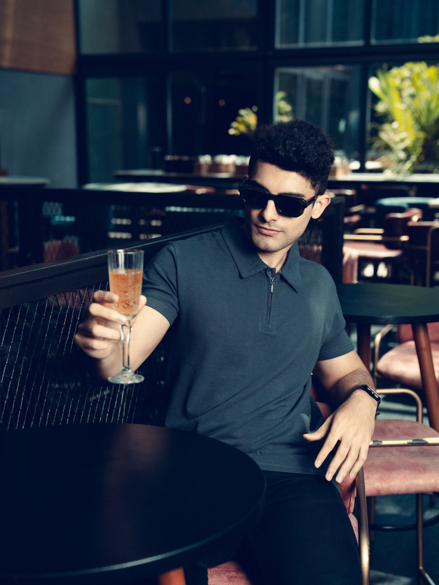 A man wearing a Monkstory Bamboo Cotton Zip-Polo Tee - Iron Grey shirt.