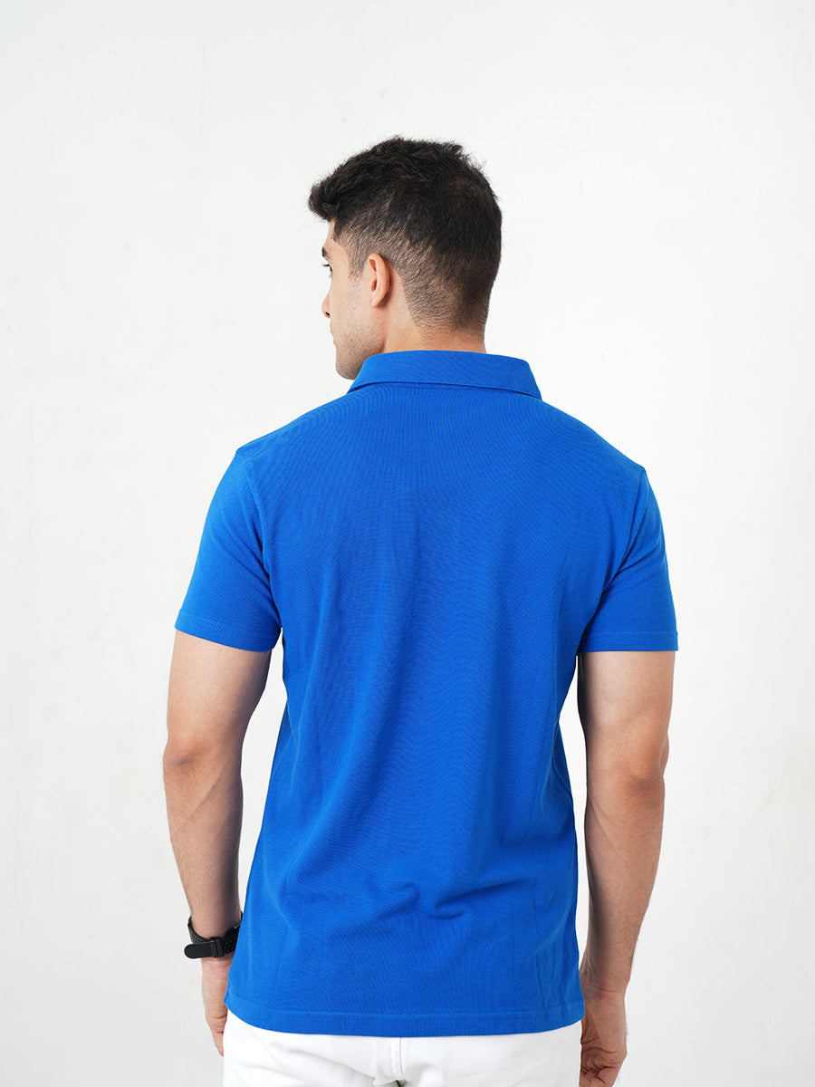 A man in a Monkstory Bamboo Cotton Polo Tee - Cobalt Blue posing for a photo, showcasing the breathable comfort and softness of the fabric.