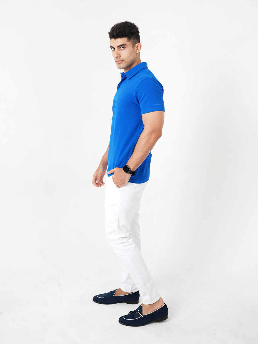 A man in a Monkstory Bamboo Cotton Polo Tee - Cobalt Blue posing for a photo, showcasing the breathable comfort and softness of the fabric.