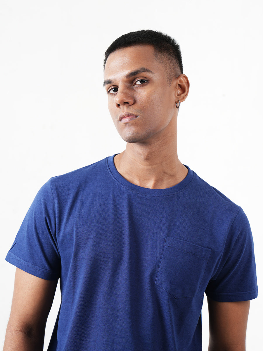The Monkstory Bamboo Cotton Crew Tee, made of bamboo and cotton, features a man wearing a Midnight Blue t-shirt with a pocket.