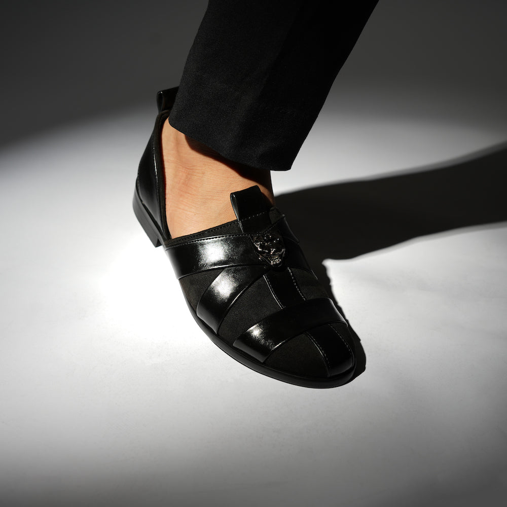 A sophisticated Monkstory Criss Cross Slip-On Sandal - Black leather shoe with straps.
