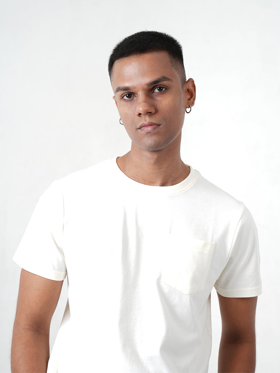 A man in a Monkstory Bamboo Cotton Crew Tee - Warm Ivory posing for a photo.