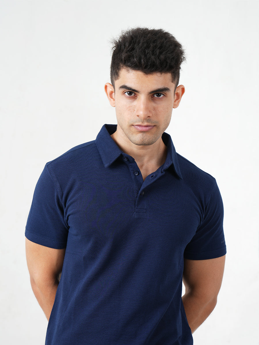 A man in a comfortable Monkstory Bamboo Cotton Polo Tee - Navy Blue posing for a photo.