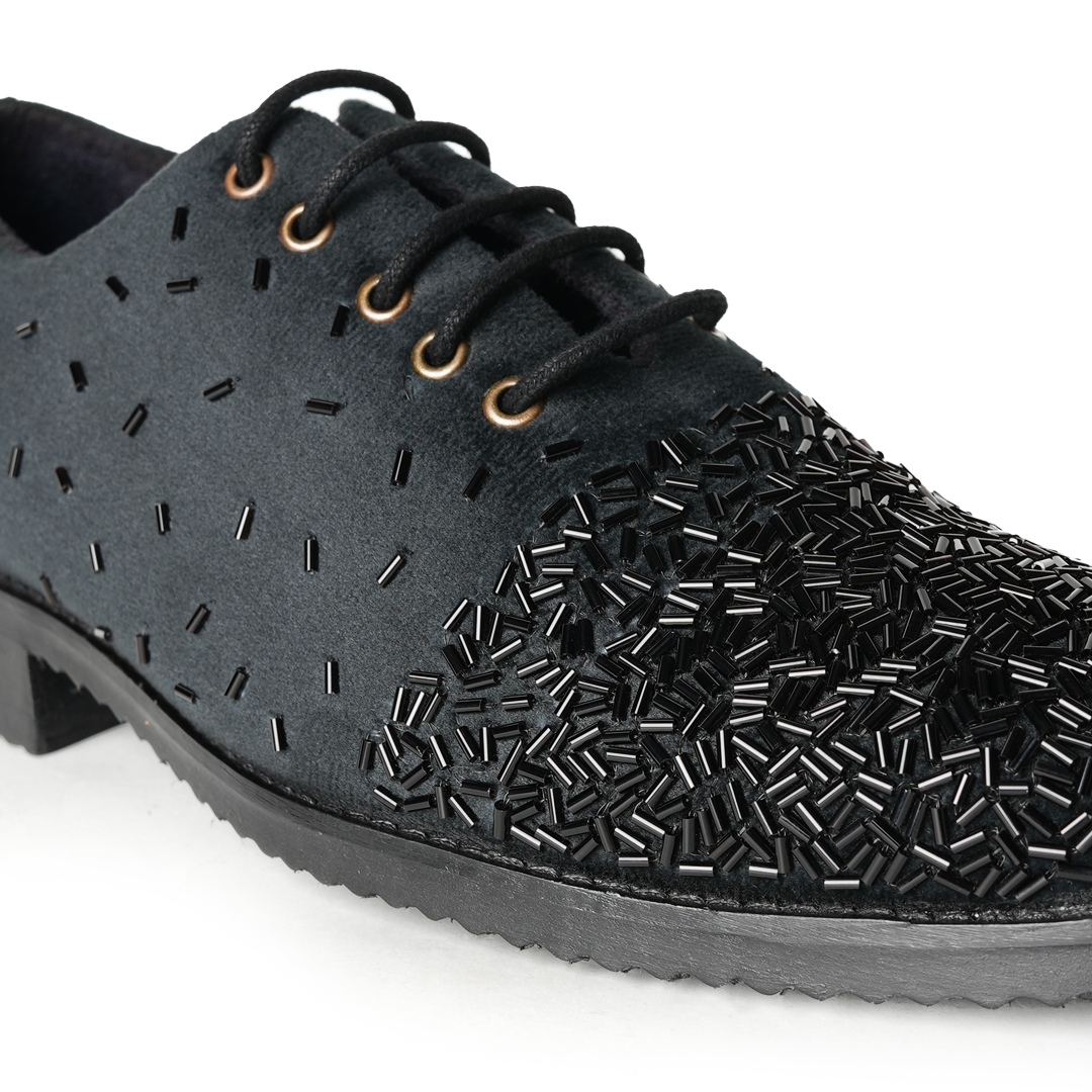 A stylish Monkstory Artisan Lace-Up - Black adorned with sequins, showcasing exquisite craftsmanship.