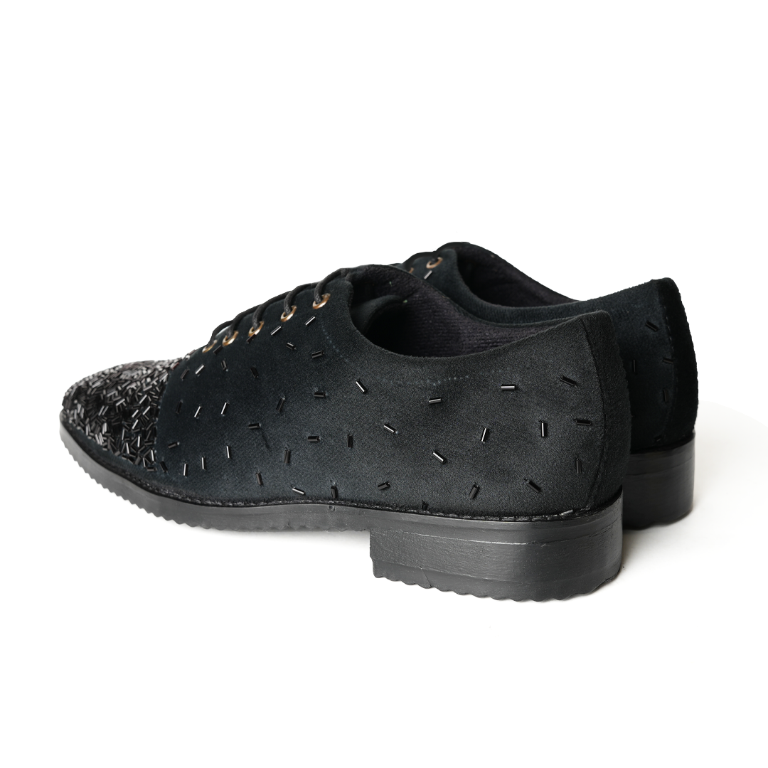 A stylish Monkstory Artisan Lace-Up - Black adorned with sequins, showcasing exquisite craftsmanship.