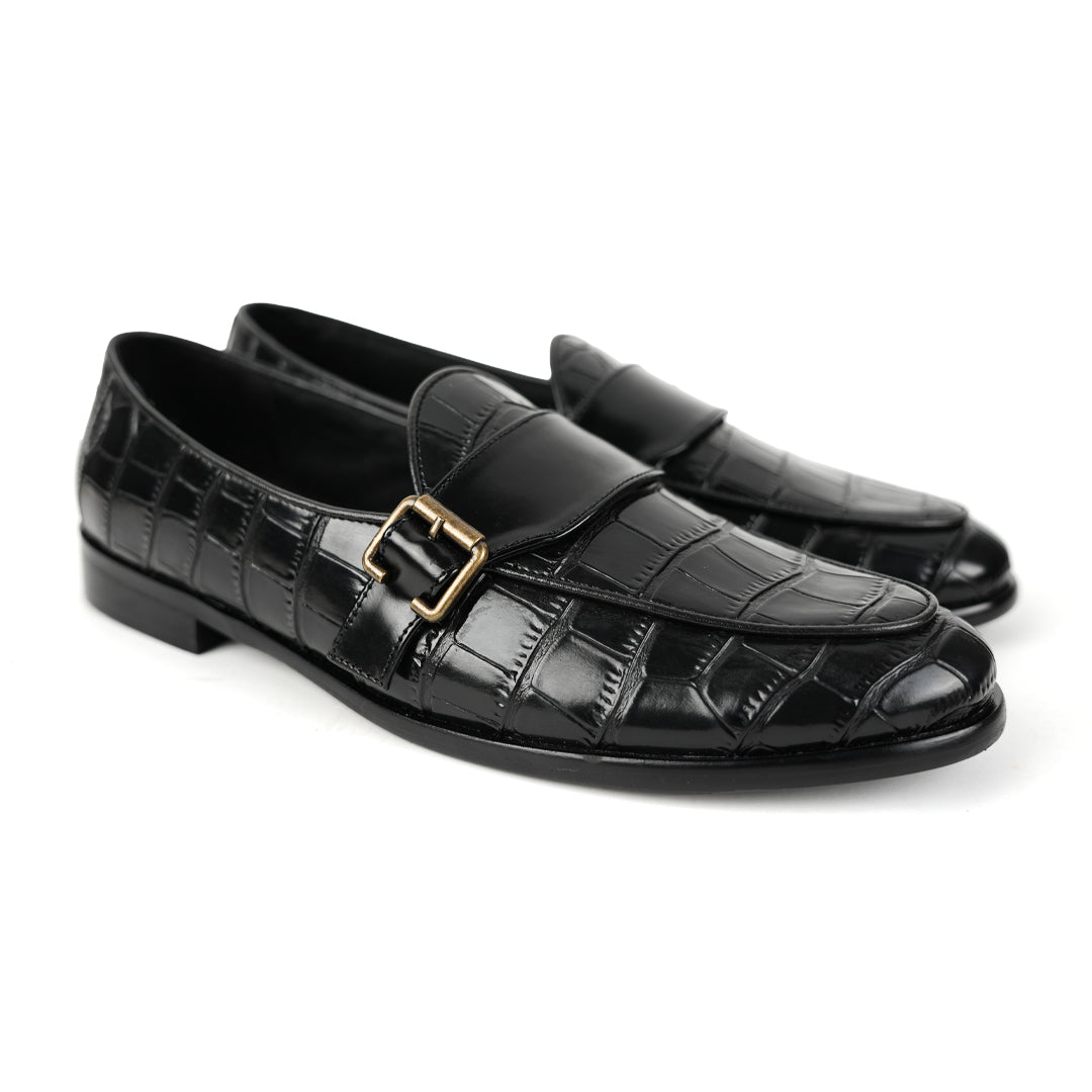 A sleek black Monkstory Croco Print Formal Shoes with a gold buckle.