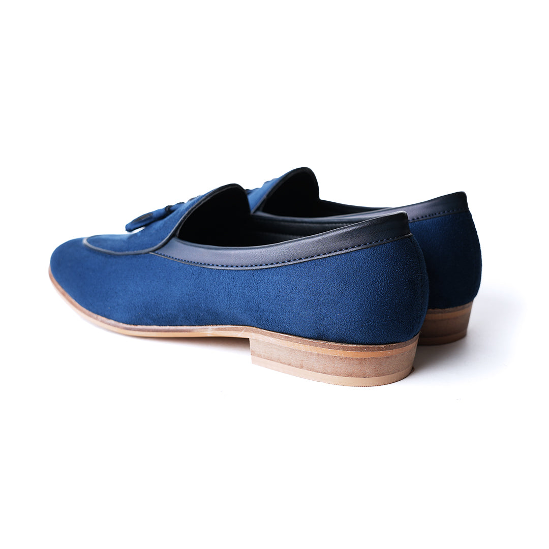 An eco-conscious blue suede Monkstory loafer with tassels, showcasing sustainability.
