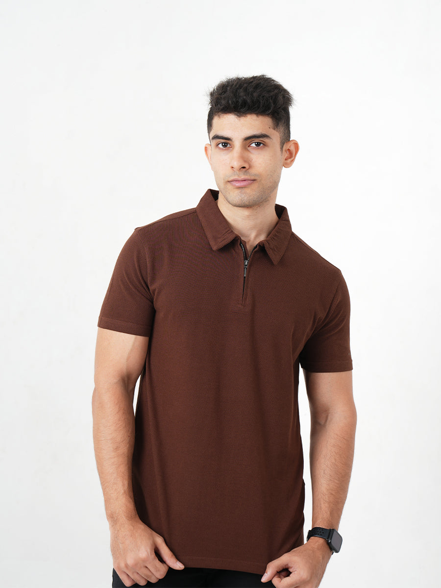 A man in a sophisticated Monkstory Bamboo Cotton Zip-Polo Tee, exuding comfort with his hands placed gently on his chest.