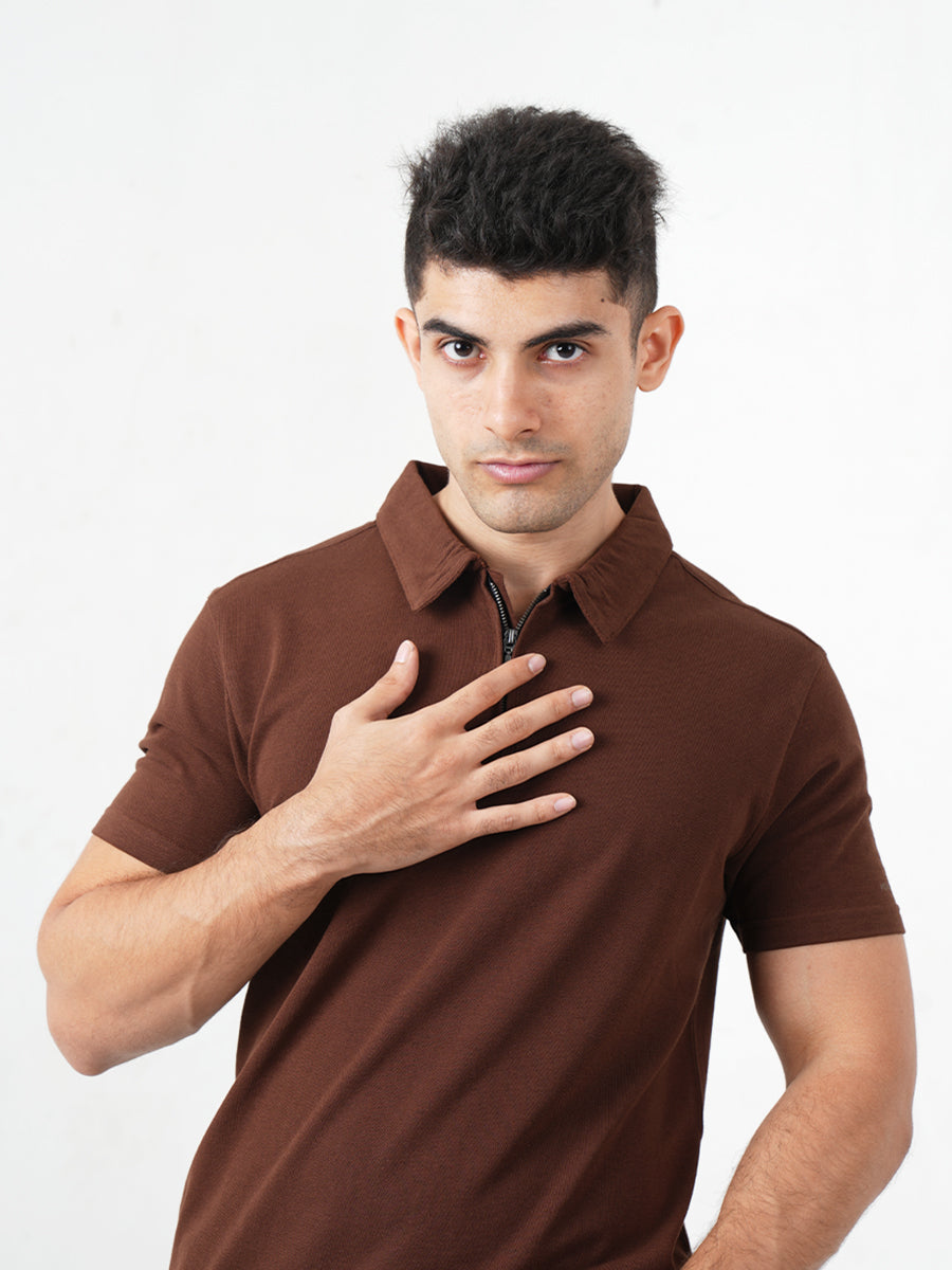 A man in a sophisticated Monkstory Bamboo Cotton Zip-Polo Tee, exuding comfort with his hands placed gently on his chest.