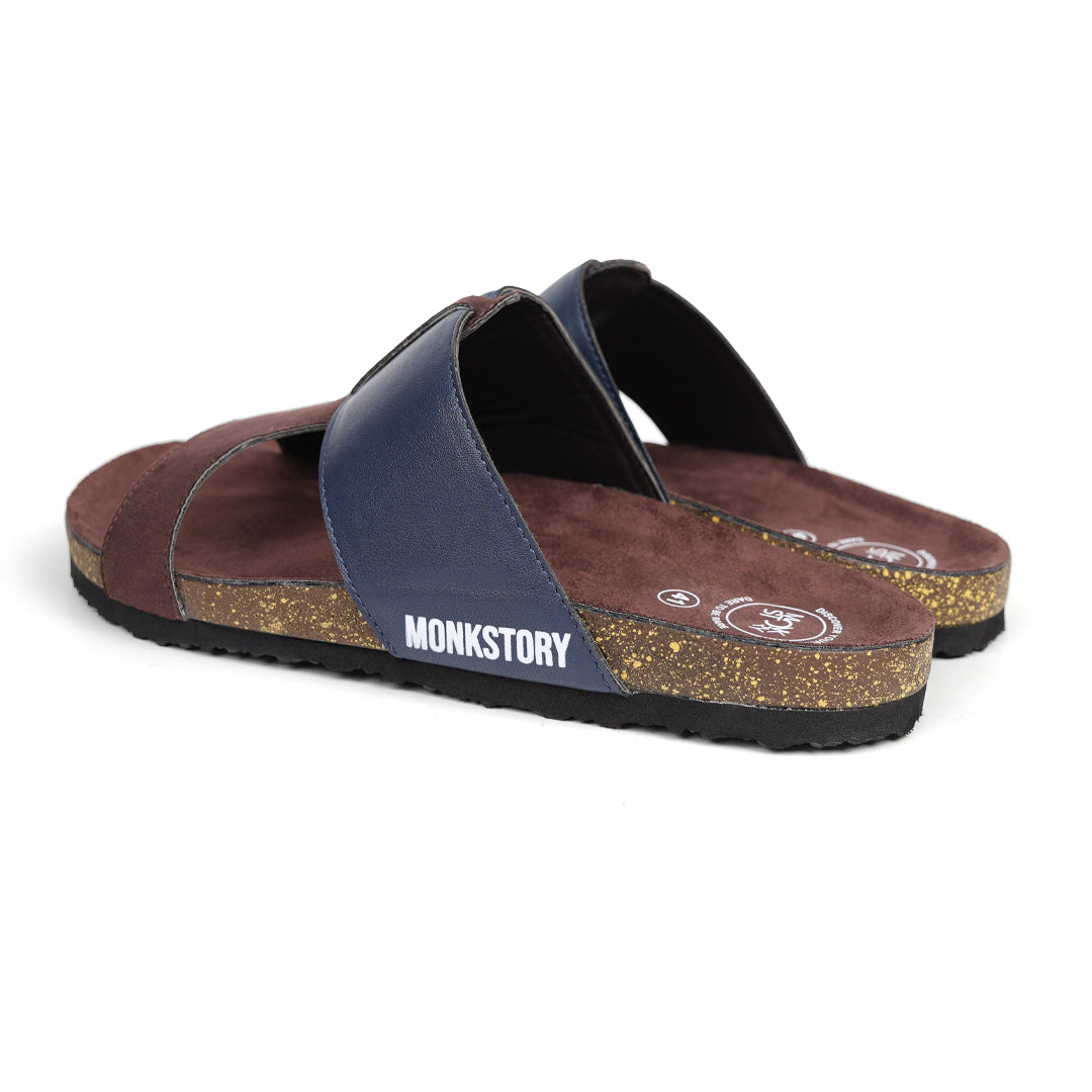 A pair of brown and blue Monkstory Cork Cross-Strap Sandals on a white background.