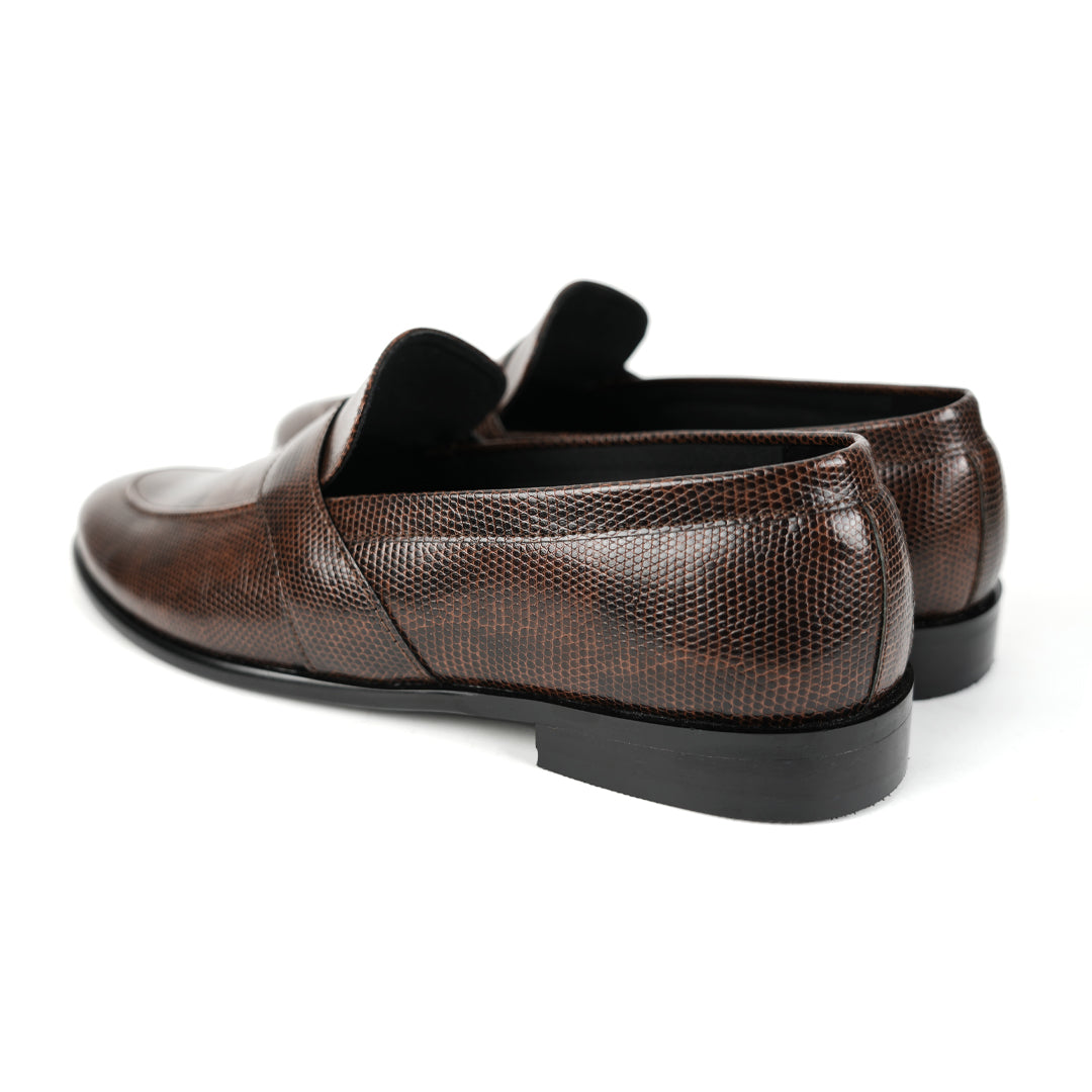 A stylish men's Monkstory brown loafer with a grain pattern on a white background.