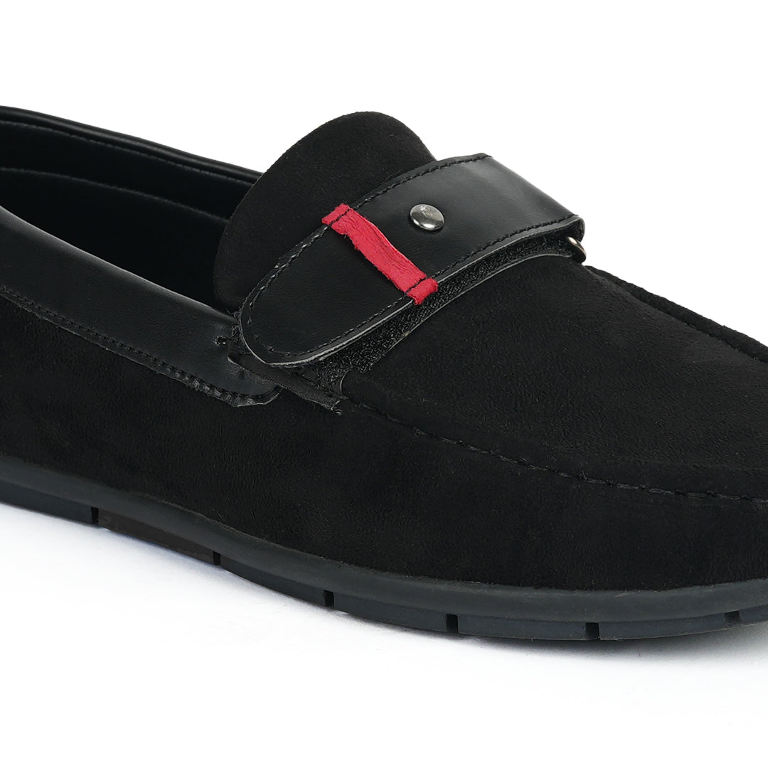 A comfortable Monkstory black loafer with a red stripe, perfect for driving.