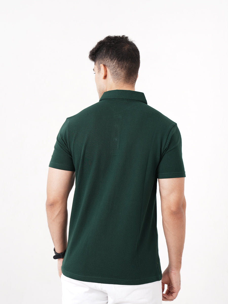 A man wearing a Monkstory Bamboo Cotton Polo Tee - Pine Green, a versatile option from Monkstory.