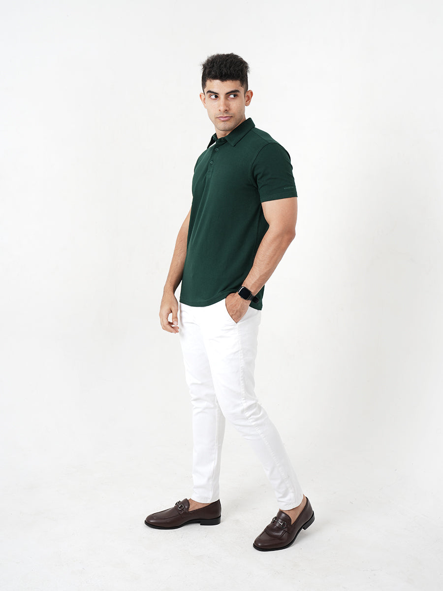 A man wearing a Monkstory Bamboo Cotton Polo Tee - Pine Green, a versatile option from Monkstory.