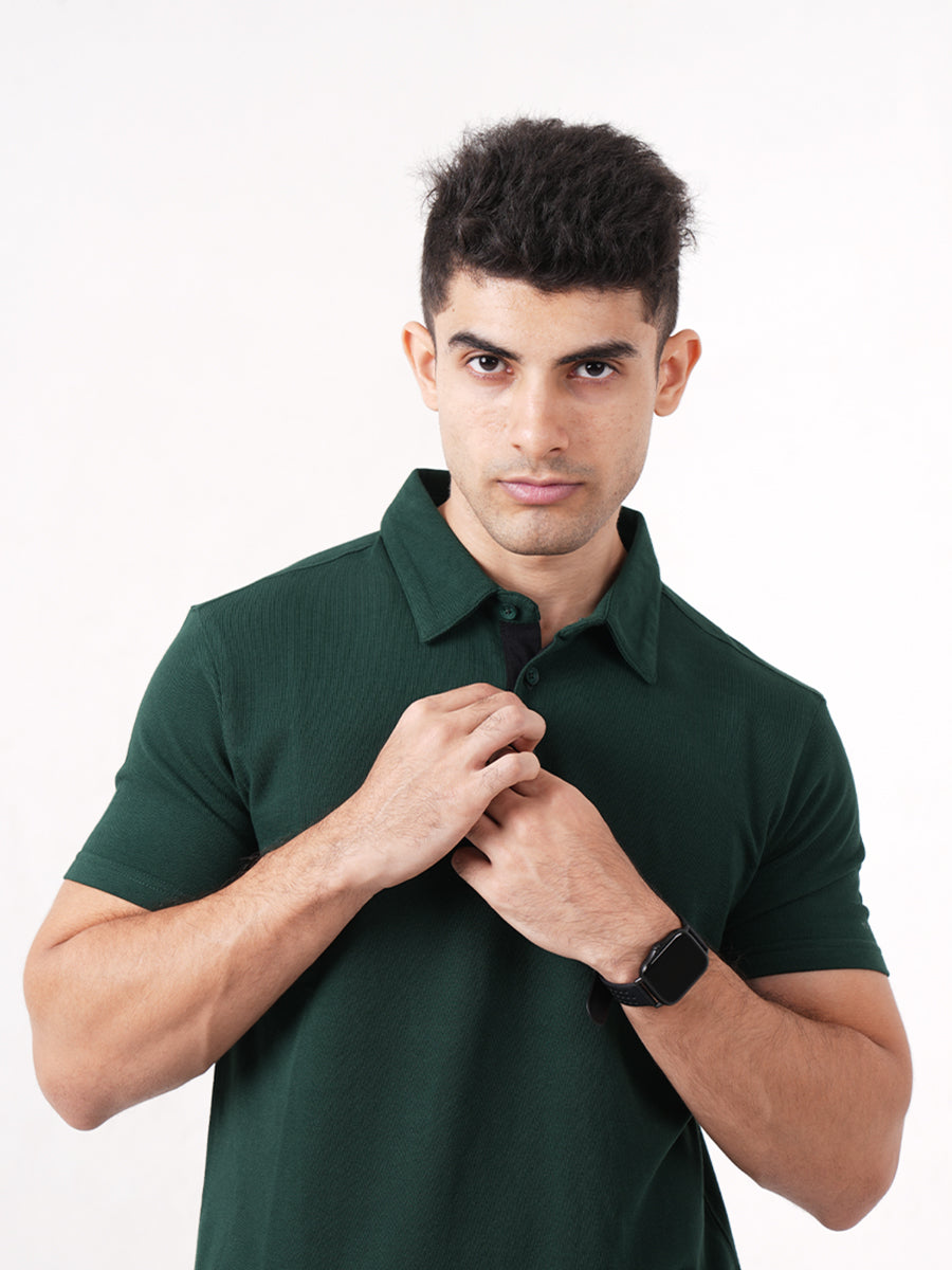 A man wearing a Monkstory Bamboo Cotton Polo Tee - Pine Green, a versatile option from Monkstory.