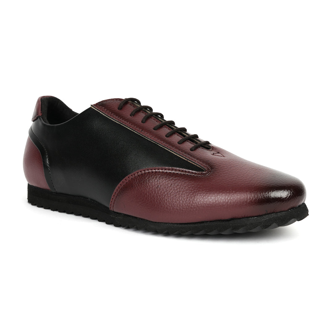 A fashionable Monkstory Dual Colour Smart Sneaker in burgundy and black leather that offers comfort.