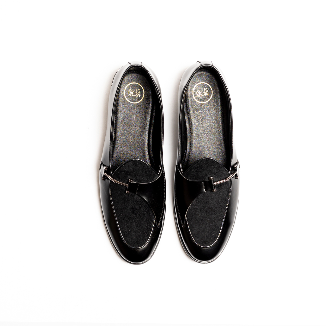 An Eclecta Side Buckle Slip On - Black/Black made of vegan leather.