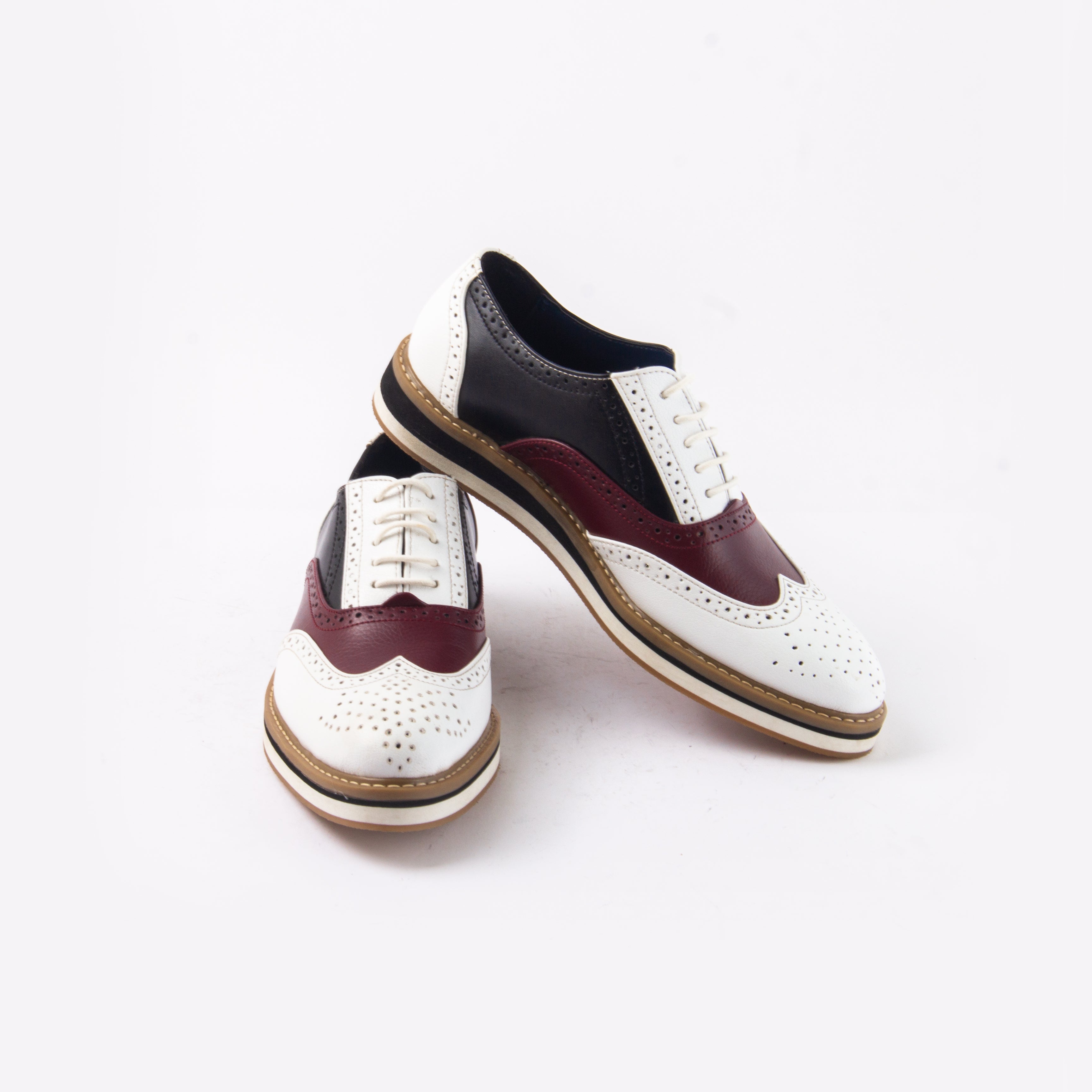 A white and burgundy wingtip oxford shoe that showcases Beverly Tricolour Brogues' design sensibilities with a touch of drama, from monkstory.