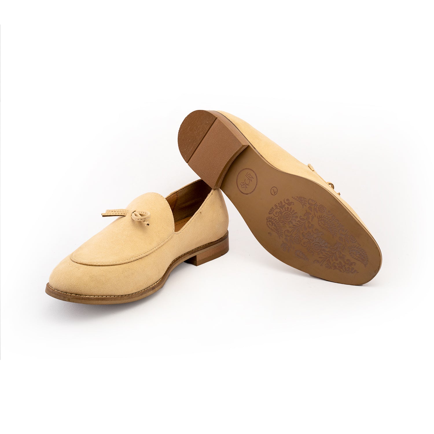 A pastel beige Wyld Faux-Suede Slip-On loafer with a tassel on the toe, perfect for fashion-forward individuals seeking pro-environment and vegan choices in their monkstory footwear.