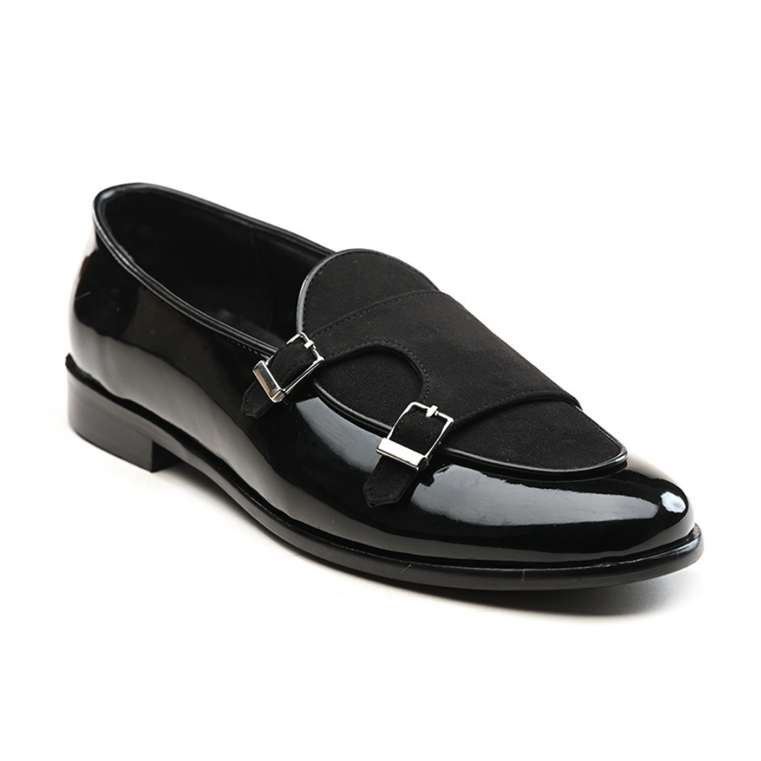 A black leather loafer with two buckles featuring posh shine.
Product: Monkstory Luxious Patent Double Monk Slip Ons - Black.