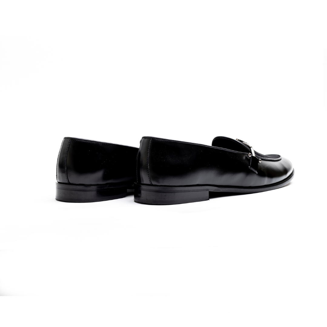 An Eclecta Side Buckle Slip On - Black/Black made of vegan leather.