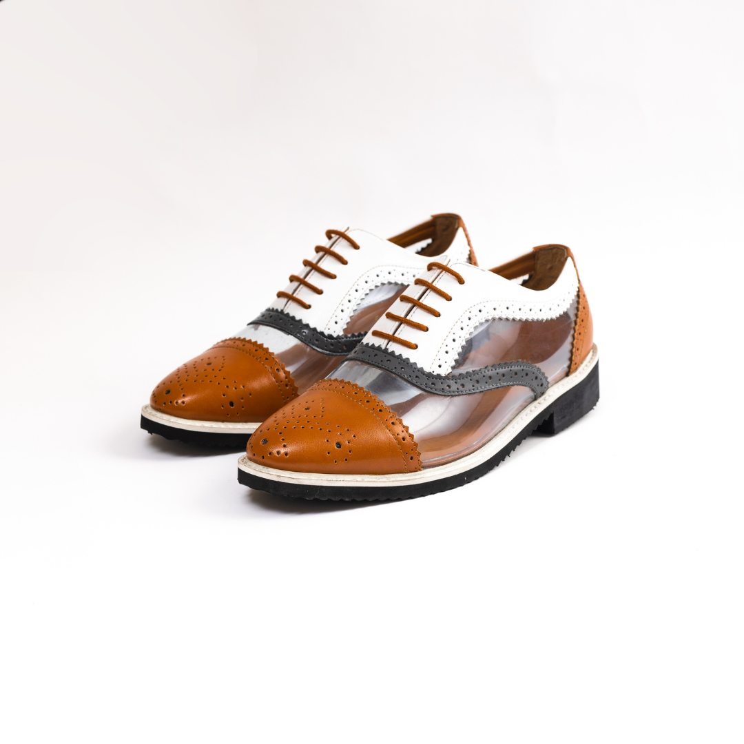 A pair of brown and white Trance Tricolour Transparent Brogues with clear soles made from PU Leather.