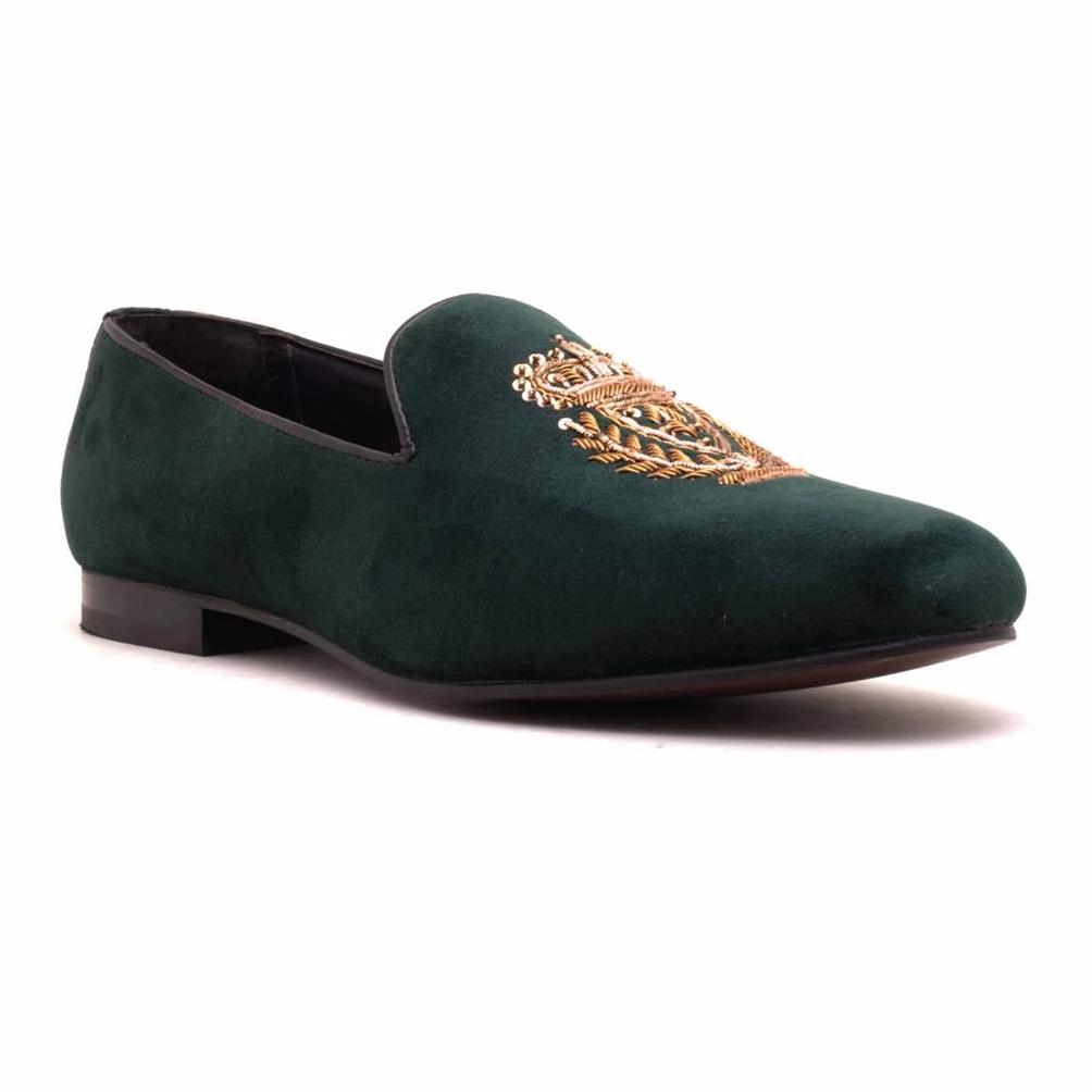 A pair of Ross Green Velvet Slip Ons with a gold crest, making them Monkstory designer shoes.