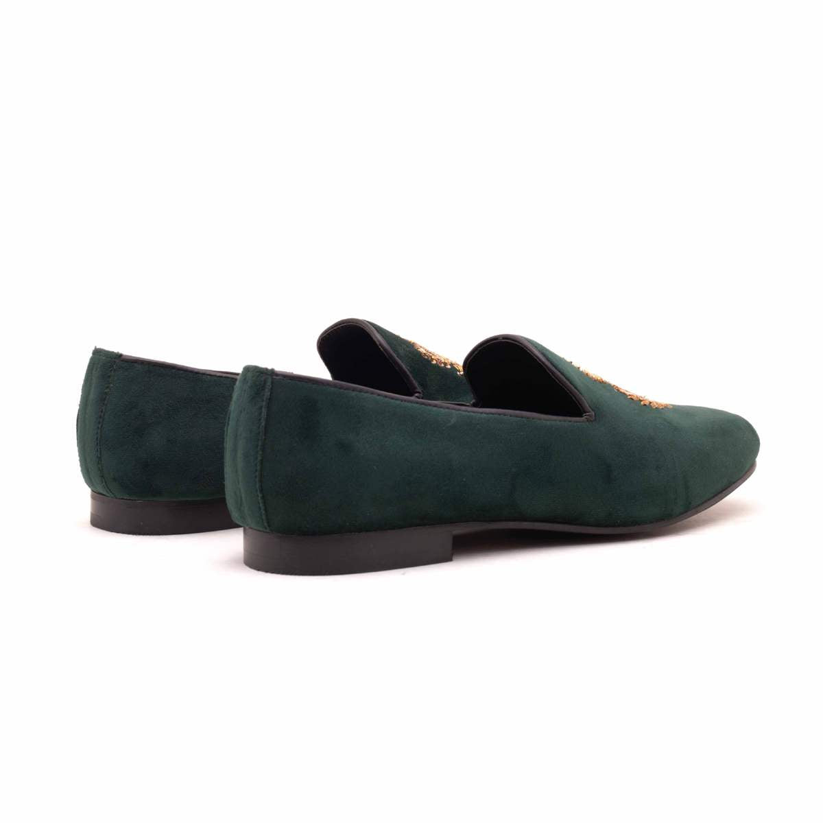 A pair of Ross Green Velvet Slip Ons with a gold crest, making them Monkstory designer shoes.