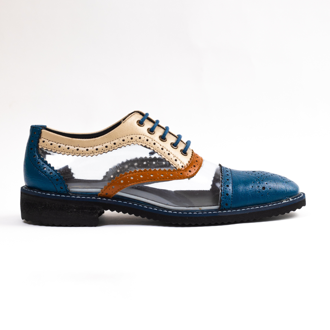 A pair of blue Trance Tricolour Transparent Brogues - Royale shoes featuring monkstory PU Leather accents.