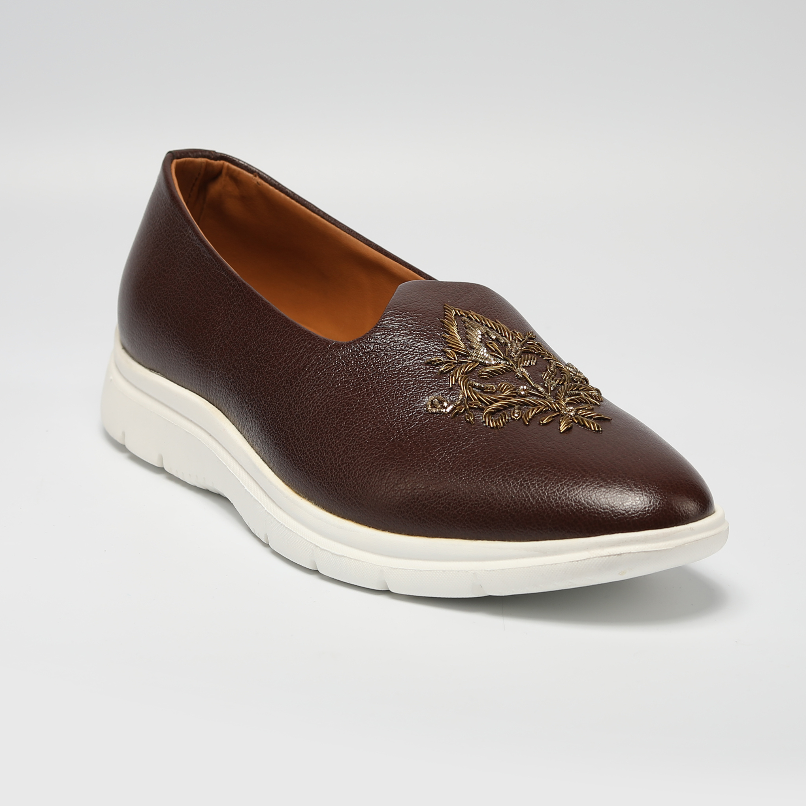 A brown leather slip on shoe with an embroidered design, perfect for those seeking an ethnic touch to their footwear collection - Monkstory ReMx Mojari Sneakers.