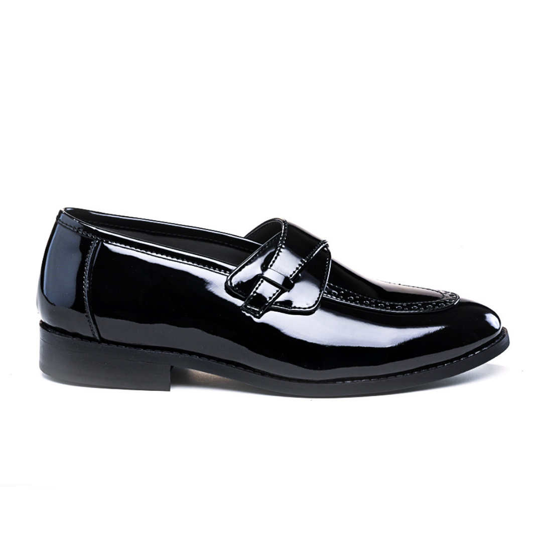 A pair of Drezzire Classic Patent Slip-Ons - Black from monkstory on a white background.