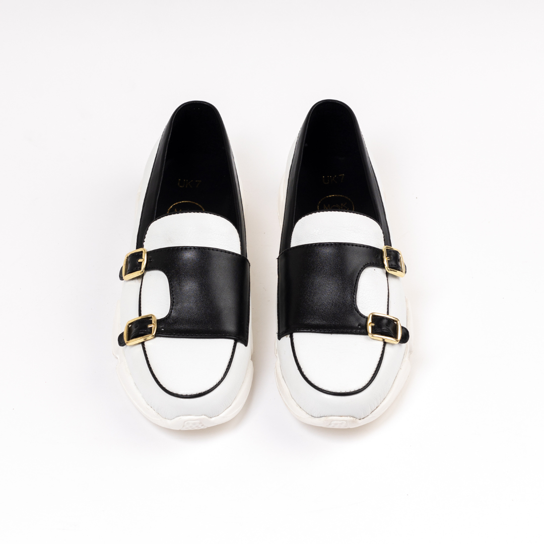 A stylish white/black Chunky Double Monk Sneaker from monkstory with two buckles.