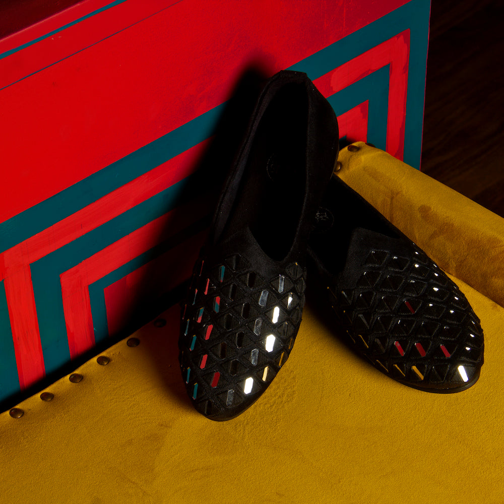 A stylish black Mirror Mojari slip on shoe with studs on the side, providing both comfort and style by Monkstory.