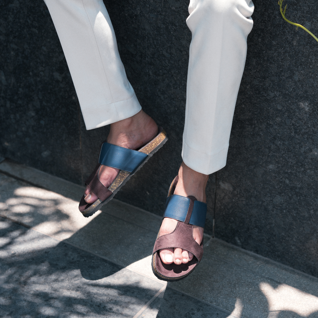 A pair of brown and blue Monkstory Cork Cross-Strap Sandals on a white background.