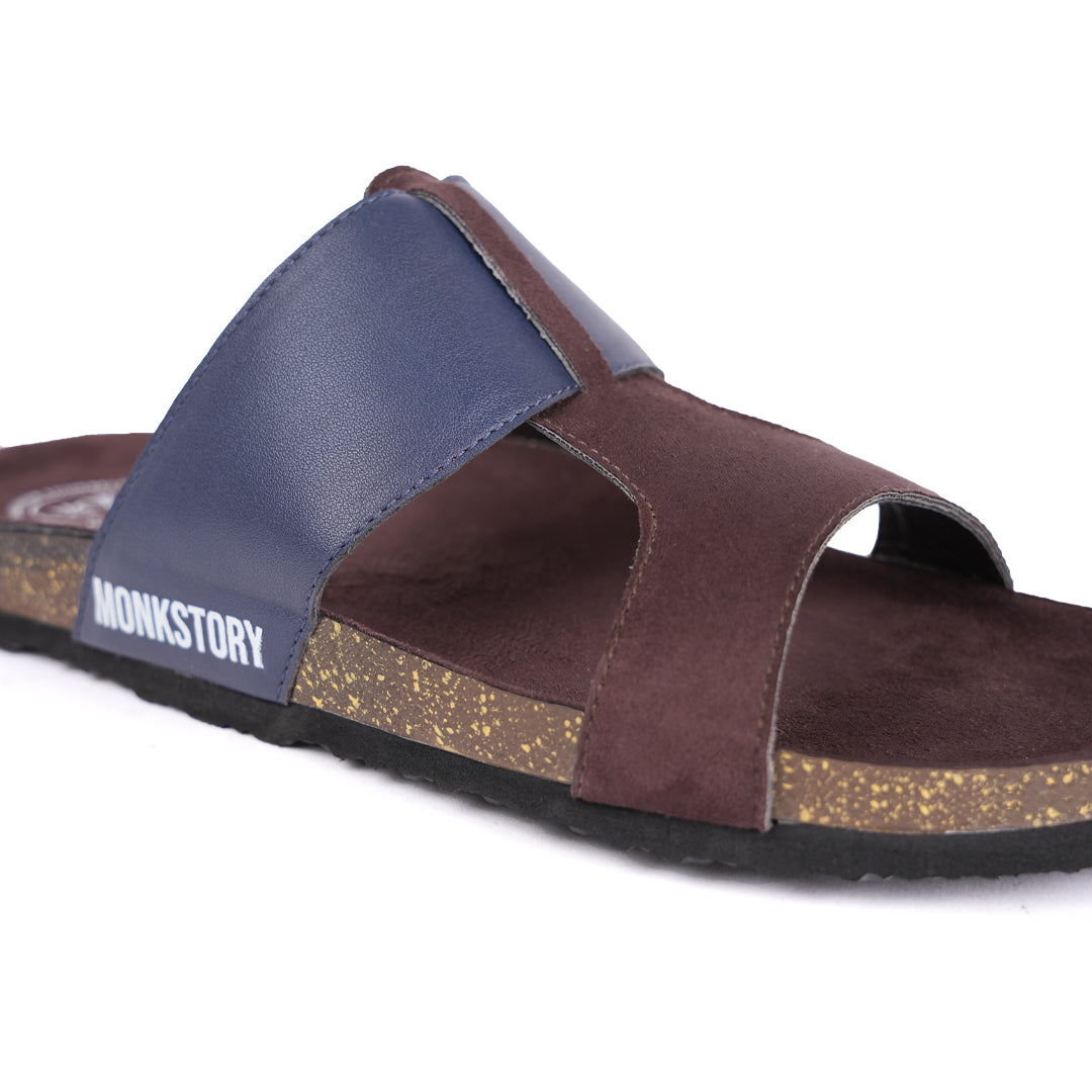 A pair of brown and blue Monkstory Cork Cross-Strap Sandals on a white background.