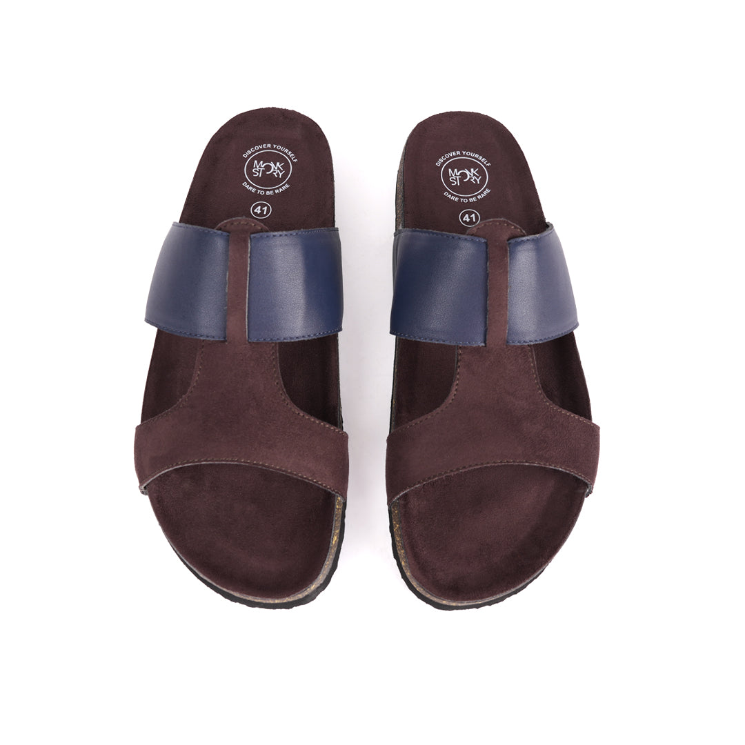 A pair of brown and blue Monkstory Cork Cross-Strap Sandals on a white background.