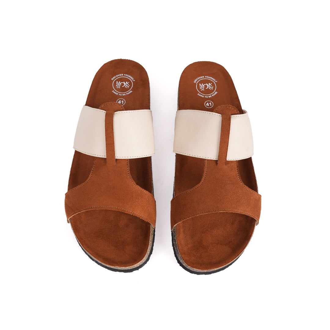 A pair of tan and cream Monkstory Cork Cross-Strap Sandals on a white background.